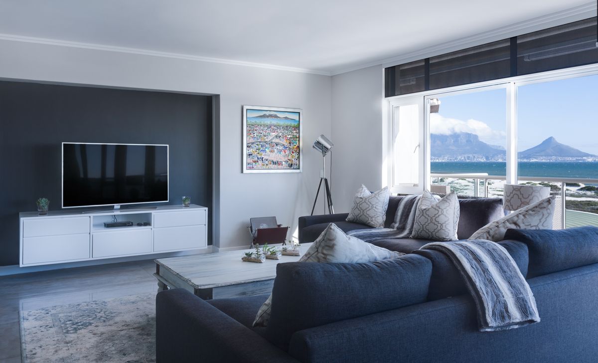 A furnished living room with different sources of light