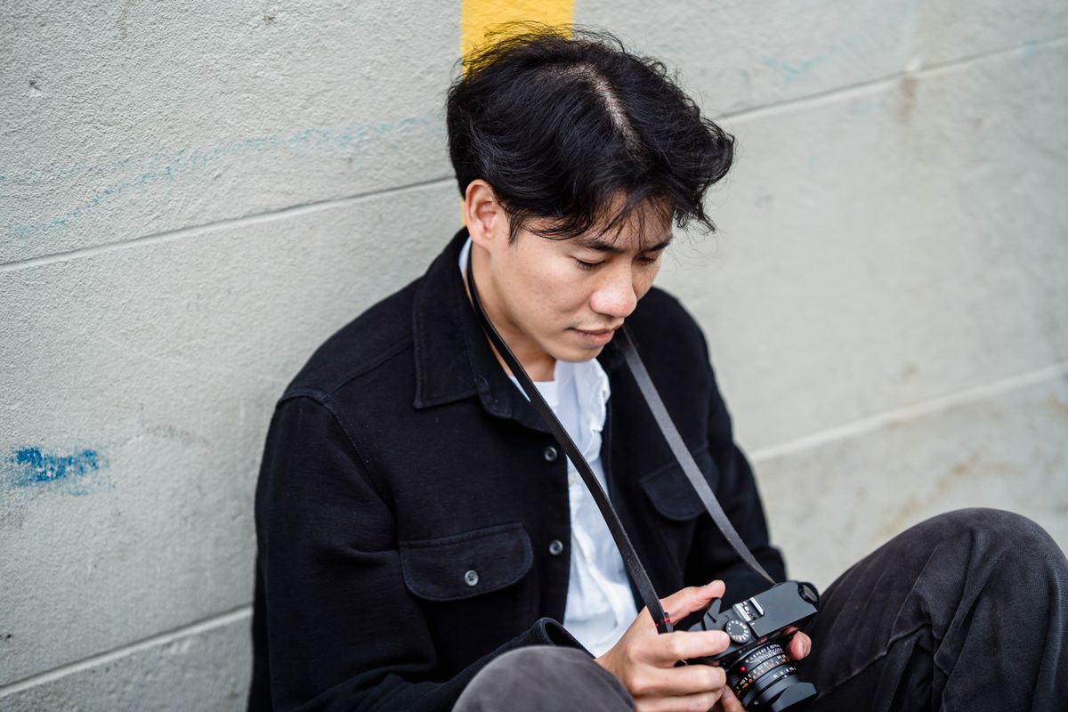 A photographer reviewing a camera
