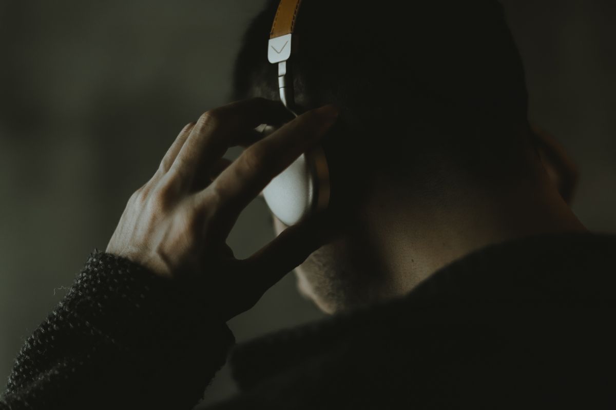 A person listening through headphones